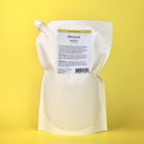 White refill pouch with a label on a yellow background