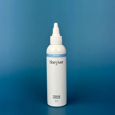 White bottle of tiberiver makeup remover on a blue background