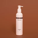 White bottle with pump on a brown background