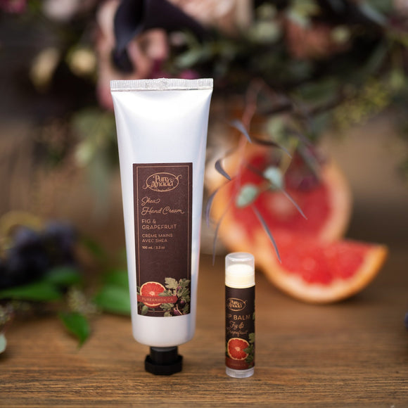 Hand cream and small bottle on a wooden surface with flowers in the background
