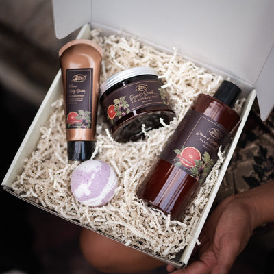Set of skincare products in a box held by a person