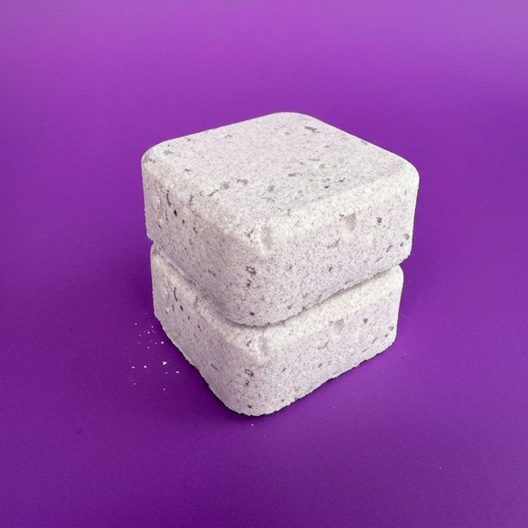 Two stacked concrete blocks on a purple background