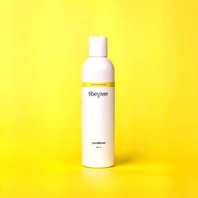 White bottle of Libe River conditioner on a yellow background