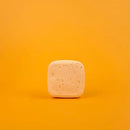 Square bar of soap on a gradient orange background