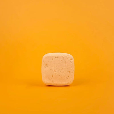 Square bar of soap on a gradient orange background