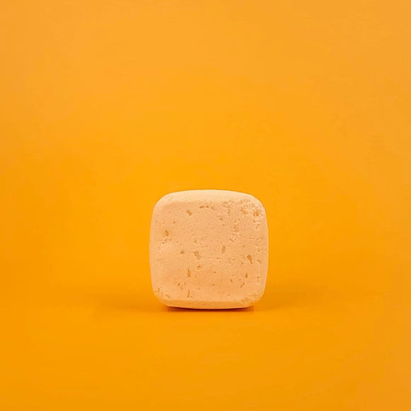 Square bar of soap on a gradient orange background