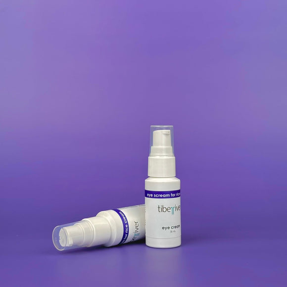 Two white spray bottles with 'tiberius' branding on a purple background