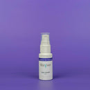 White bottle of eye cream with a blue label on a purple background