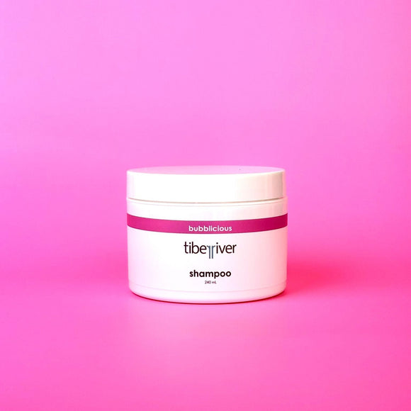 Tiberiver shampoo jar on a pink gradient background